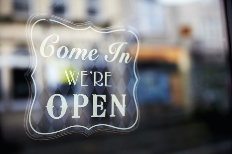 A sign etched in glass, Come In, We're Open.